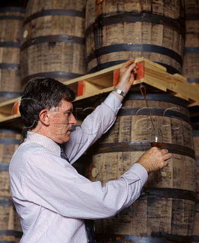 Barry Crockett Head Distiller checks on the   progress of whiskey maturing in barrel at the   Midleton Distillery Midleton County Cork Ireland