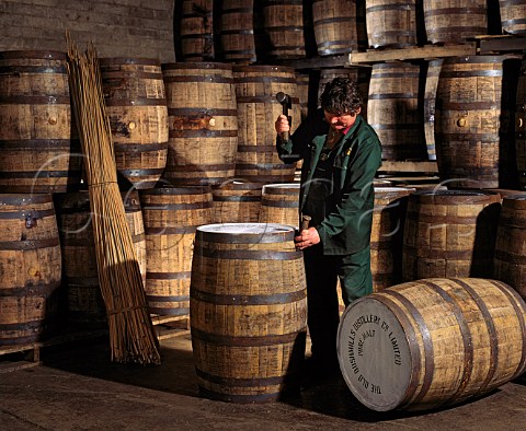 Tightening the hoops on a whiskey barrel   Old   Bushmills Distillery Bushmills CoAntrim Northern   Ireland