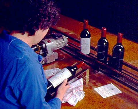 Affixing labels by hand to bottles of 1949 Chteau    Latour  Pauillac Gironde France   Mdoc  Bordeaux
