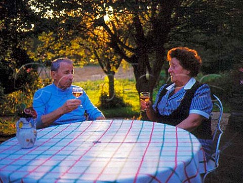 Couple enjoying a glass of ros wine on their patio