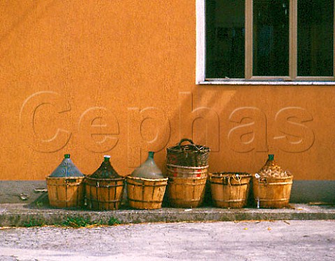 Baskets and demijohns outside winery in Montecarlo   Tuscany Italy