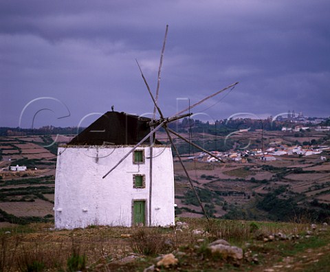 Windmill on ridge with the Mafra Royal Palace in distance  Mafra Estremadura Portugal