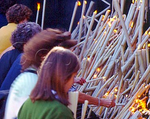 Pilgrims lighting candles by the Chapel of the Apparitions at Fatima In 1917 the Virgin Mary was said to have made six appearances to three peasant girls culminating on 13 October in the socalled Miracle of the Sun The chapel is built on the site of the oak tree in which she was said to have appeared Fatima Portugal