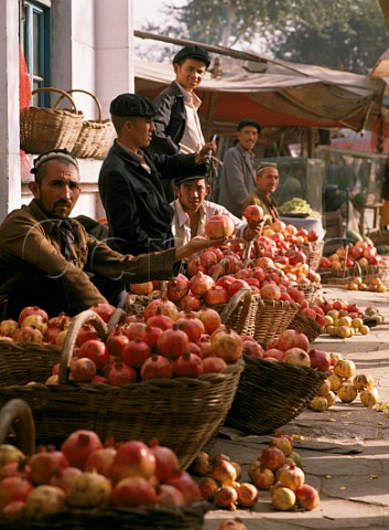Selling Pomegranates in Kashgar Sunday Market  Xinjiang Province China