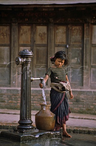 Young girl filling water jar Bhaktapur Nepal