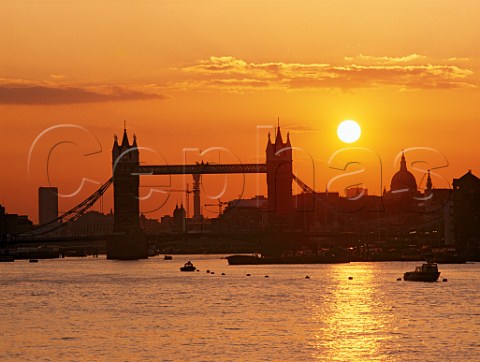 Sunset behind Tower Bridge St Pauls Cathedral and the River Thames  London