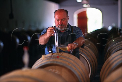 Meerlust Estate owner Hannes Mybergh  sampling wine from barrel Stellenbosch  South Africa
