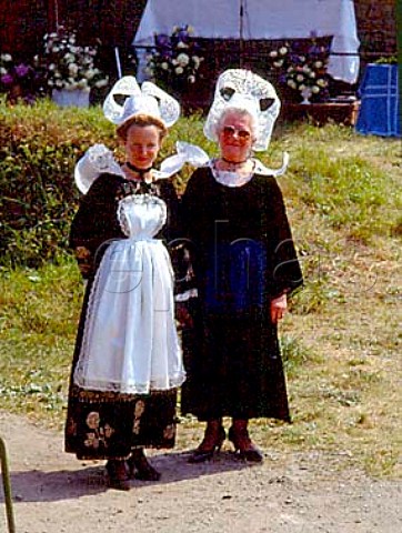 Women wearing traditional Breton Coiffe and   costumes Left Coiffe of Pont Aven Right Coiffe   of Quimperle Both made from starched lace    Pardon of Lothea near Quimperle Finistre France    Brittany
