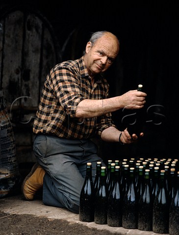 Paul Chanu examines his newly bottled Brut Cider as it undergoes its final fermentation in bottle   StMartindeSallen Normandy France