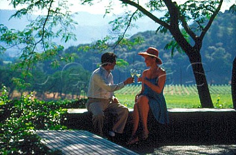 Couple drinking wine on the terrace of Joseph Phelps Winery St Helena Napa Valley California