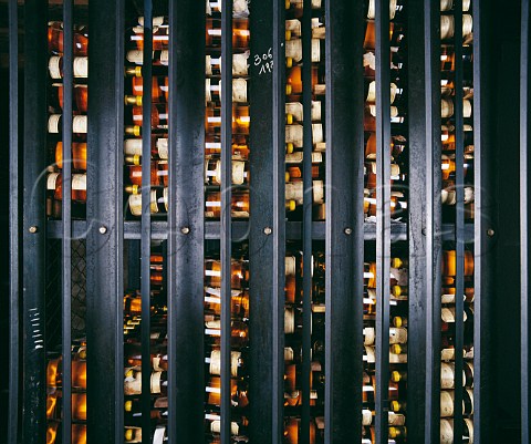 Wine behind bars in the vintage bottle cellar of Chteau dYquem Sauternes Gironde France  Sauternes  Bordeaux
