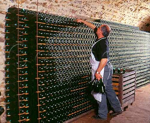 Stacking bottles to age sur lattes in the cellars   of Champagne Salon Le MesnilsurOger   Marne France  Cte des Blancs  Champagne