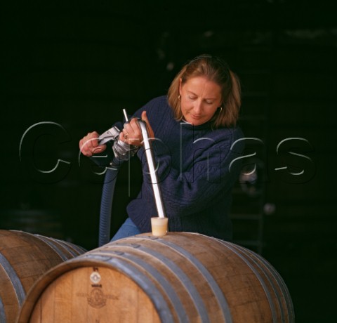 Claire Allen filling French oak barrels in winery of Huia Vineyards Marlborough New Zealand