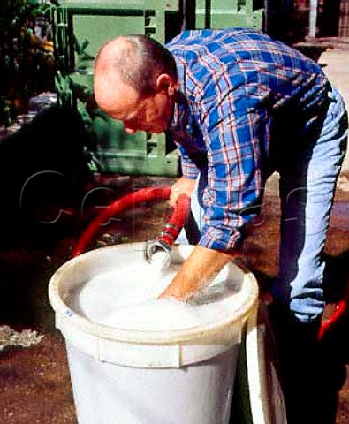 Jeff Grosset mixing bentonite with wine prior to   fining a tank of wine to remove protein  Grosset Wines Auburn South Australia   Clare Valley
