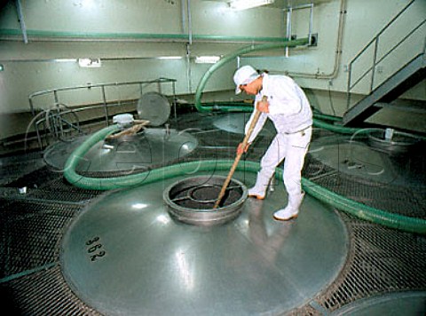 Stirring the mixture of steamed rice water and   yeast prior to fermentation in the Shikomi tanks      Sawanoi Sake Brewery  Sawai Tokyo