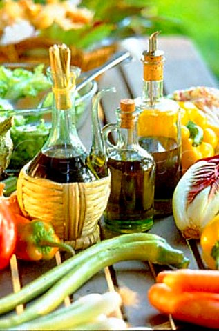 Bottles of olive oil with fresh  vegetables