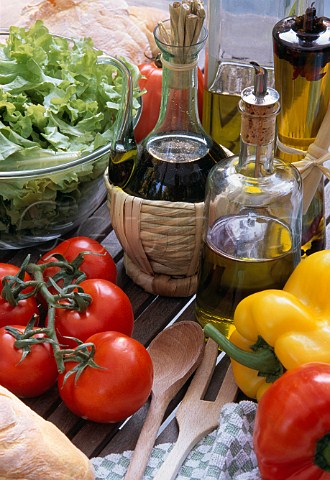 Bottles of olive oil with fresh vegetables