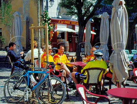 Cyclists drinking beer at terrace tables of a   caf  bar in the market square Chinon   IndreetLoire France  Touraine