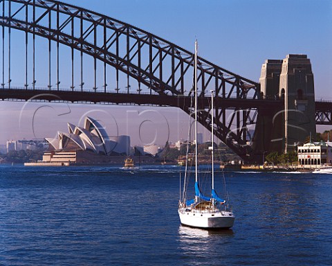 Yacht moored by Harbour Bridge and Opera House    Sydney New South Wales Australia