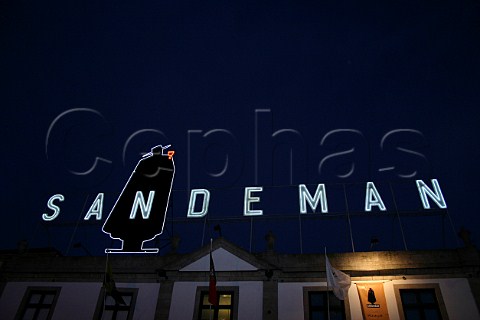 Illuminated facade of Sandeman port lodge at night   on Avenida Diogo Leite Vila Nova de Gaia Porto   Portugal