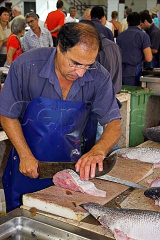 Preparing tuna fillets in the Mercado dos  Lavradores Funchal Madeira Portugal