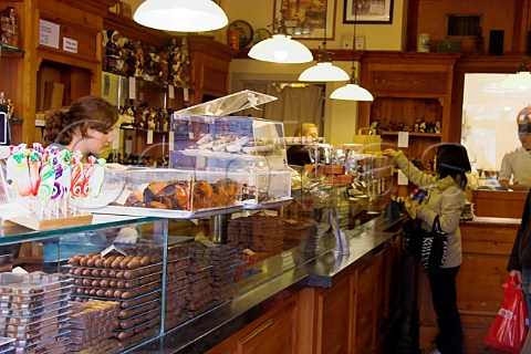 Japanese tourist in The Chocolate Line chocolate   shop Steenplein Brugge Belgium