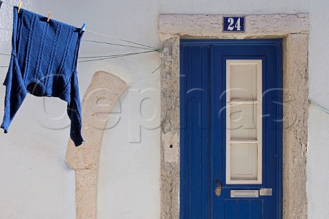 Blue sweater and blue doorway Alfama Old Lisbon    Portugal