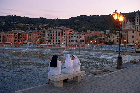 Three nuns on bench by sea at Laiguglia Liguria   Italy