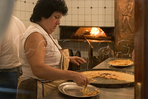 Making Farinata a traditional Ligurian pizzalike   pancake Savona Liguria Italy