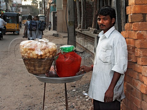 Indian man selling pan puri deep fried bread on   roadside stall Chennai Madras India