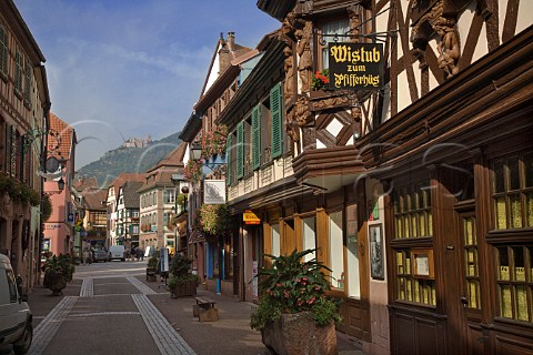 Main street in Ribeauvill with HautRibeaupierre   castle in the distance HautRhin France  Alsace