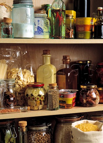 Shelves of a larder or store cupboard with dried and preserved food