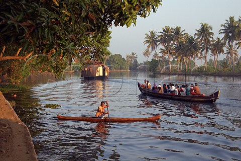 Early morning activity women being ferried on the Kuttanad the backwaters of Kerala known as the Venice of the East Kerala India