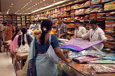 Women looking at sarees in Pothys textile store Panagal Park Chennai MadrasTamil Nadu India
