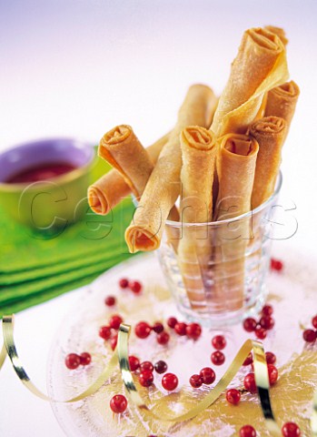 Crispy spring rolls in a glass with a dip