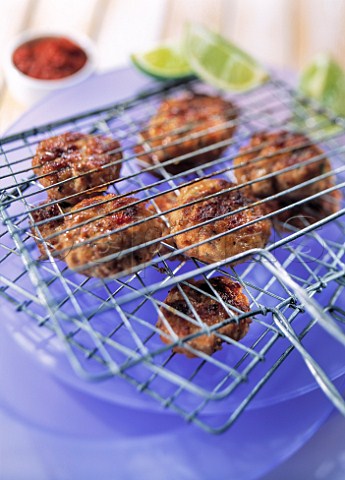 Cooked mini beefburgers in grilling rack