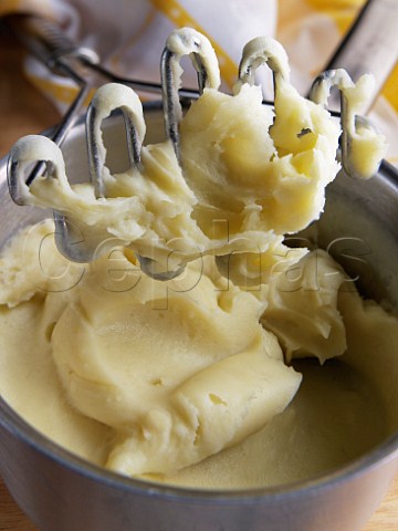 Saucepan of mashed Maris Piper potato with metal masher