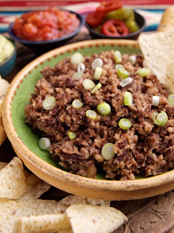 Bowl of refried beans with tacos