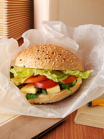 Cheese tomato and lettuce in a white sesame seed roll