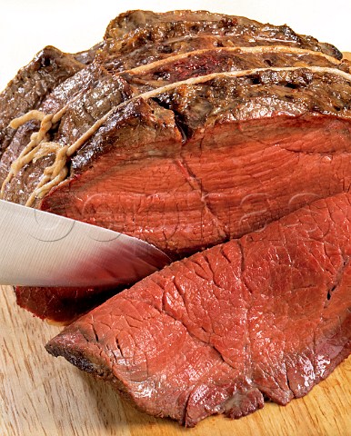 Slicing rare roast beef