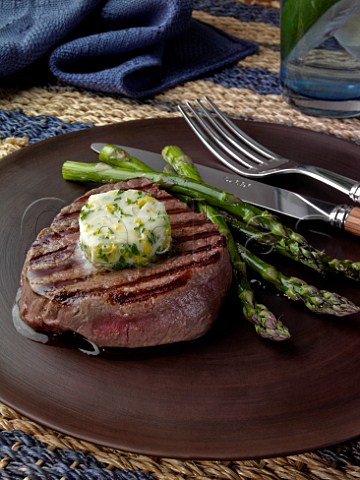 Fillet steak and grilled asparagus with herb garlic butter