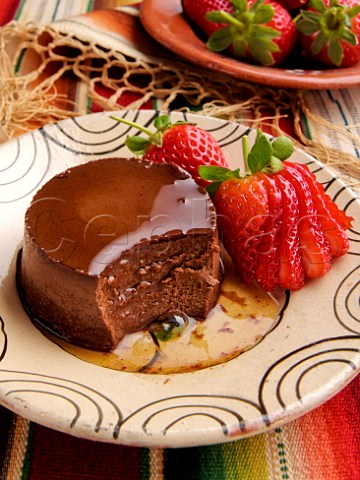 Plate of Mexican chocolate crme caramel with fresh strawberries