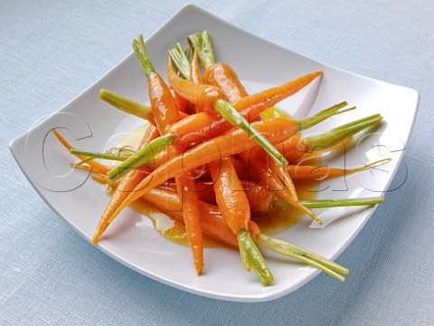 Glazed carrots on a white platter