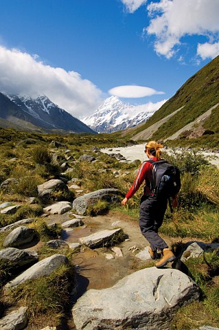 Walker on the Hooker Valley walk heading towards Mount Cook Mt CookAoraki National Park South Island New Zealand