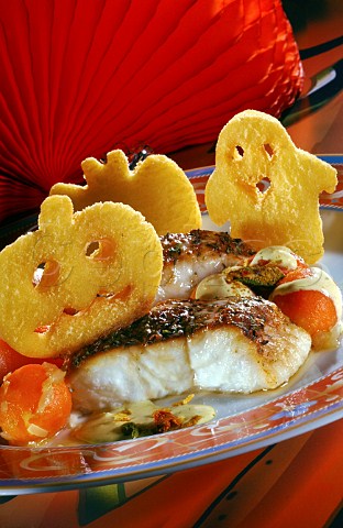 Deep fried potato shapes Halloween decorations on grilled fish meal