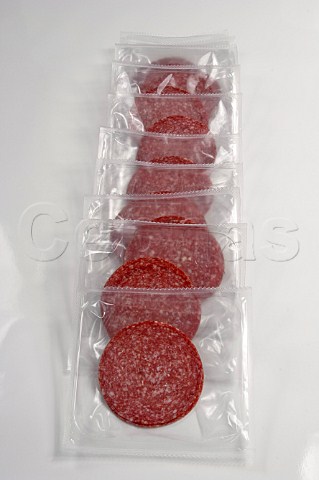 Plastic packs of sliced salami