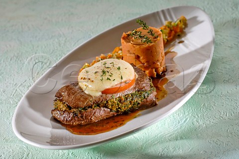 Cooked beef steak with herb butter and vegetables