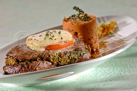 Cooked beef steak with herb butter and vegetables