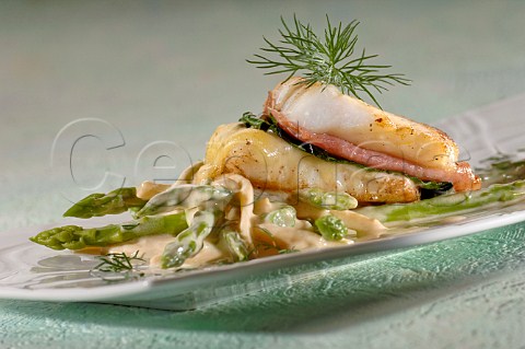 Asparagus spears with white fish bacon and cheese sauce