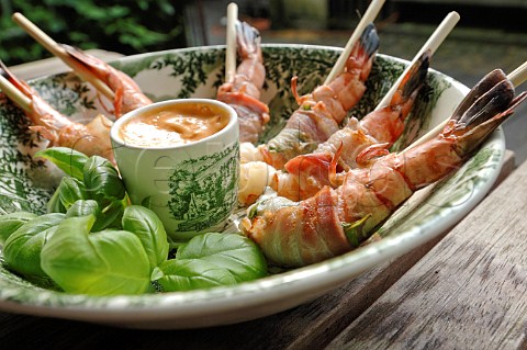 Barbecued prawns wrapped in bacon